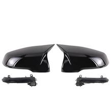 Pair of black car side mirrors on a white background